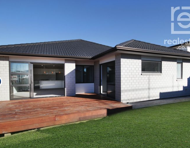 Expansive hardwood deck and landscaped lawn