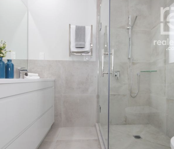 Tiled ensuite with seamless glass shower